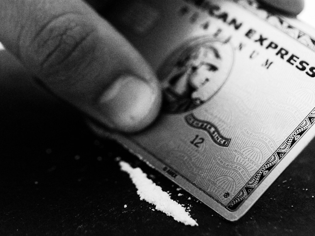 A line of cocaine is being cut with an American Express Card.