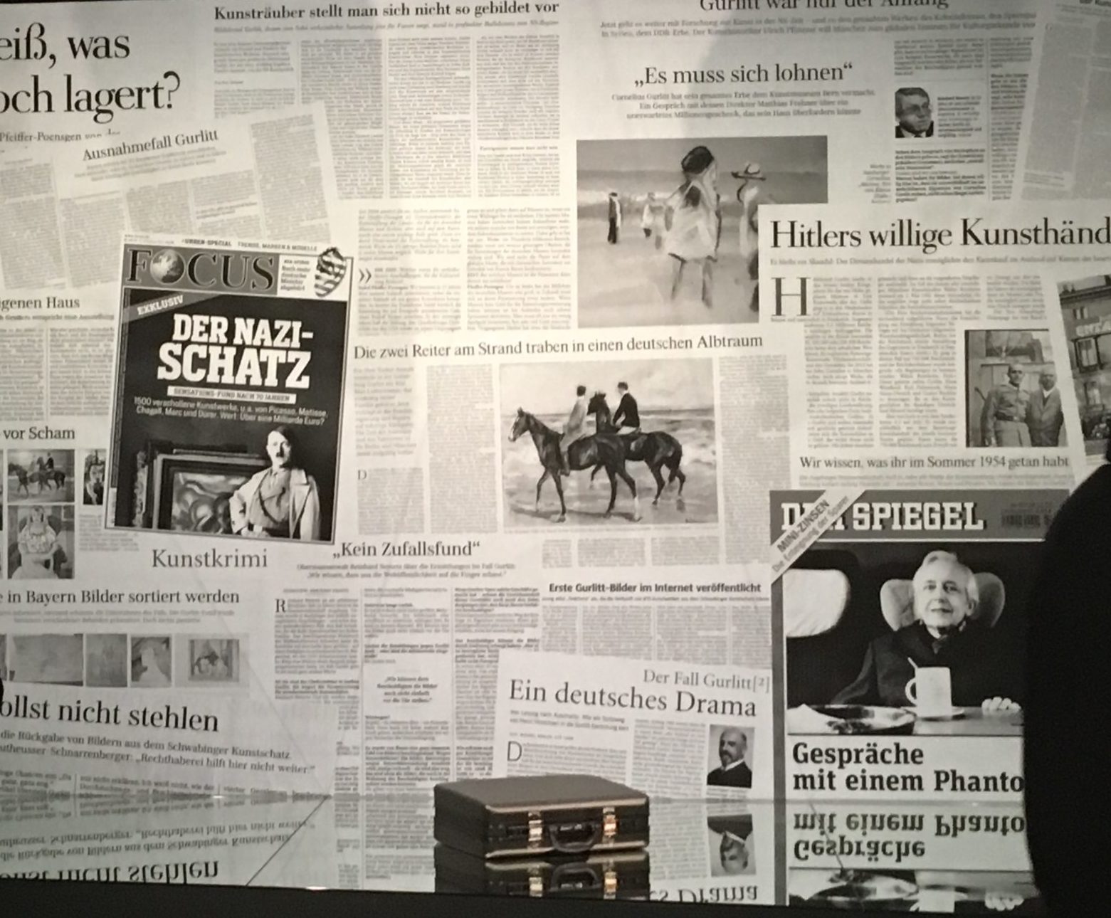 Photograph of a wall of German newspapers. 