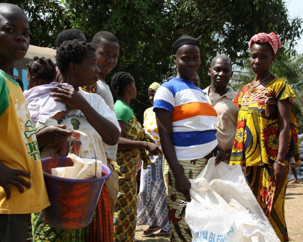 Photo of food distribution taking place at one of 76 Liberian border villages who have taken in Ivorian refugees.