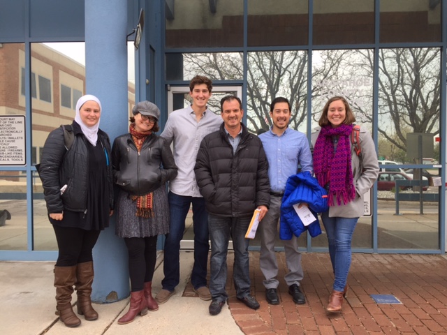 A group photograph of people standing together in front of a court house in Denver, CO.