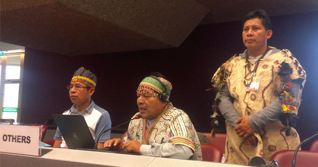 Three indigenous men sitting at a table, called "Others."