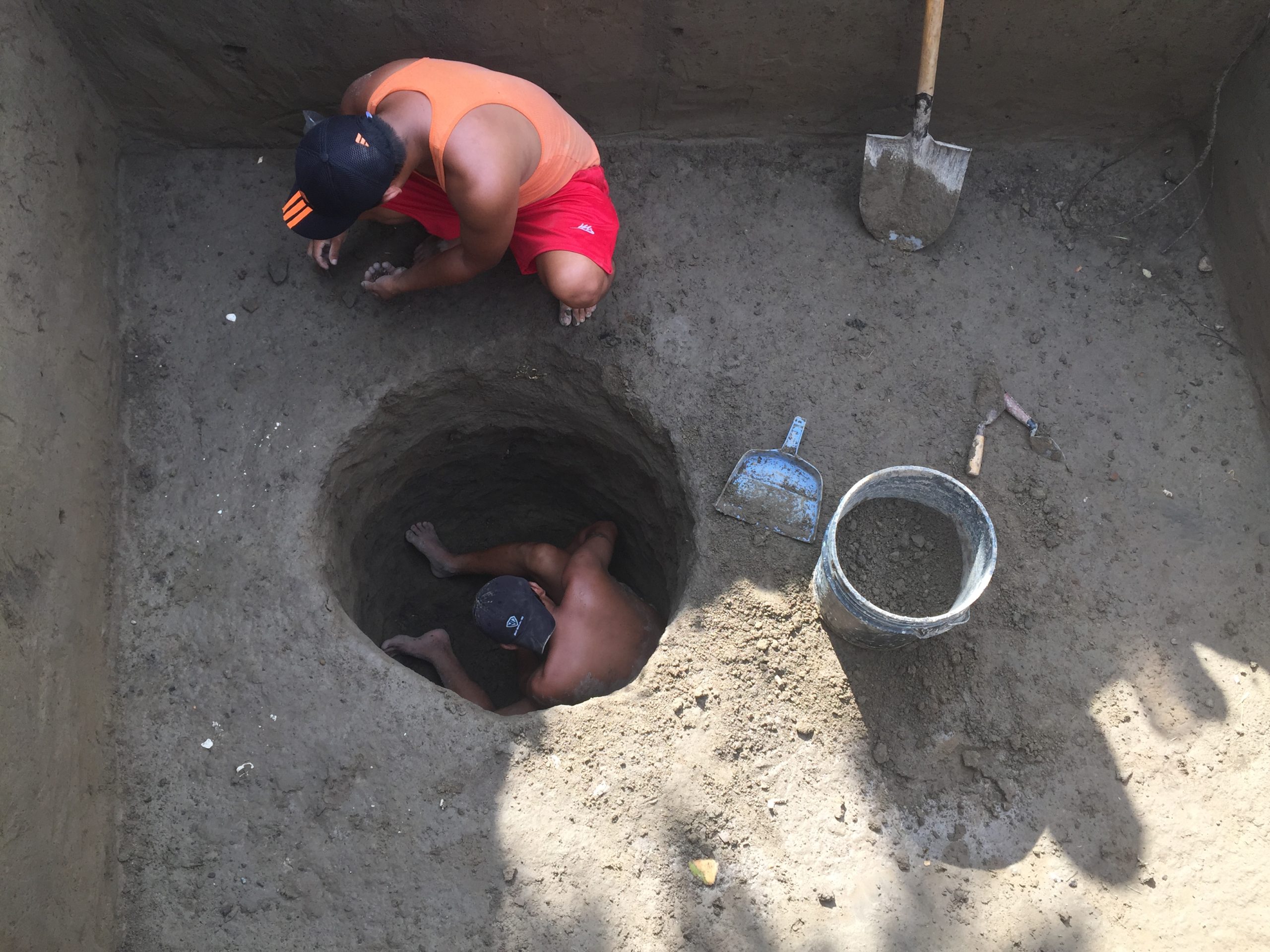 An image of two men excavating at an archaeological site.