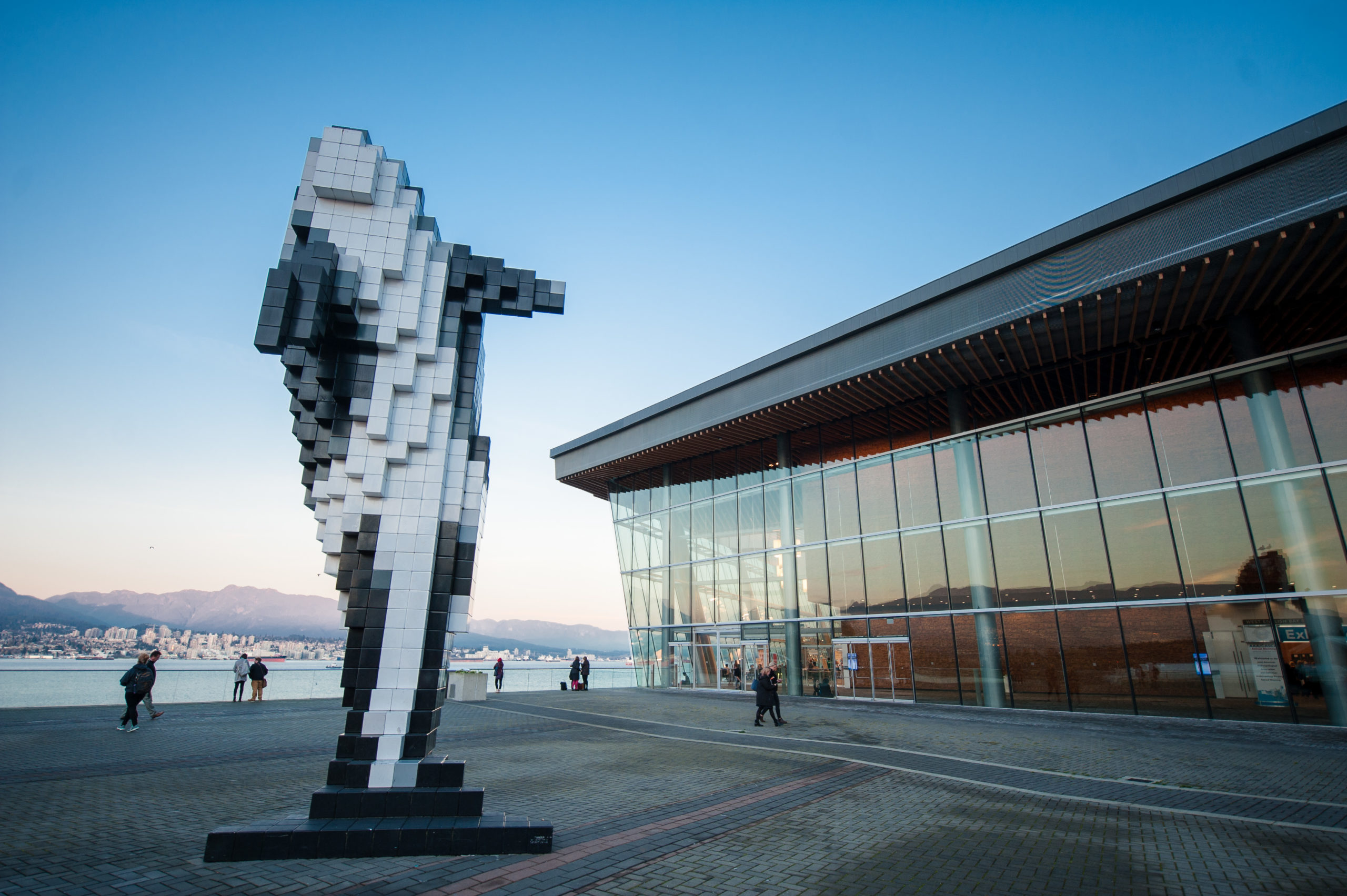 Photo of a courtyard and whale statue outside of the Vancouver Convention Center.