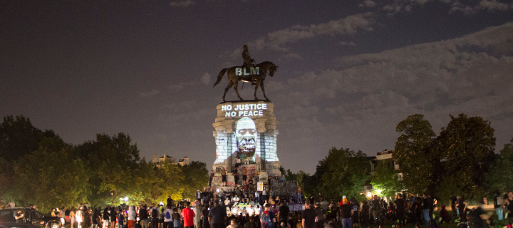 Photo of a Confederate monument during a protest
