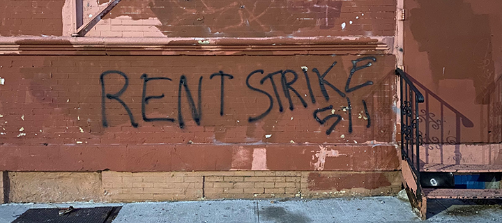 A picture of rent strike graffiti on building.