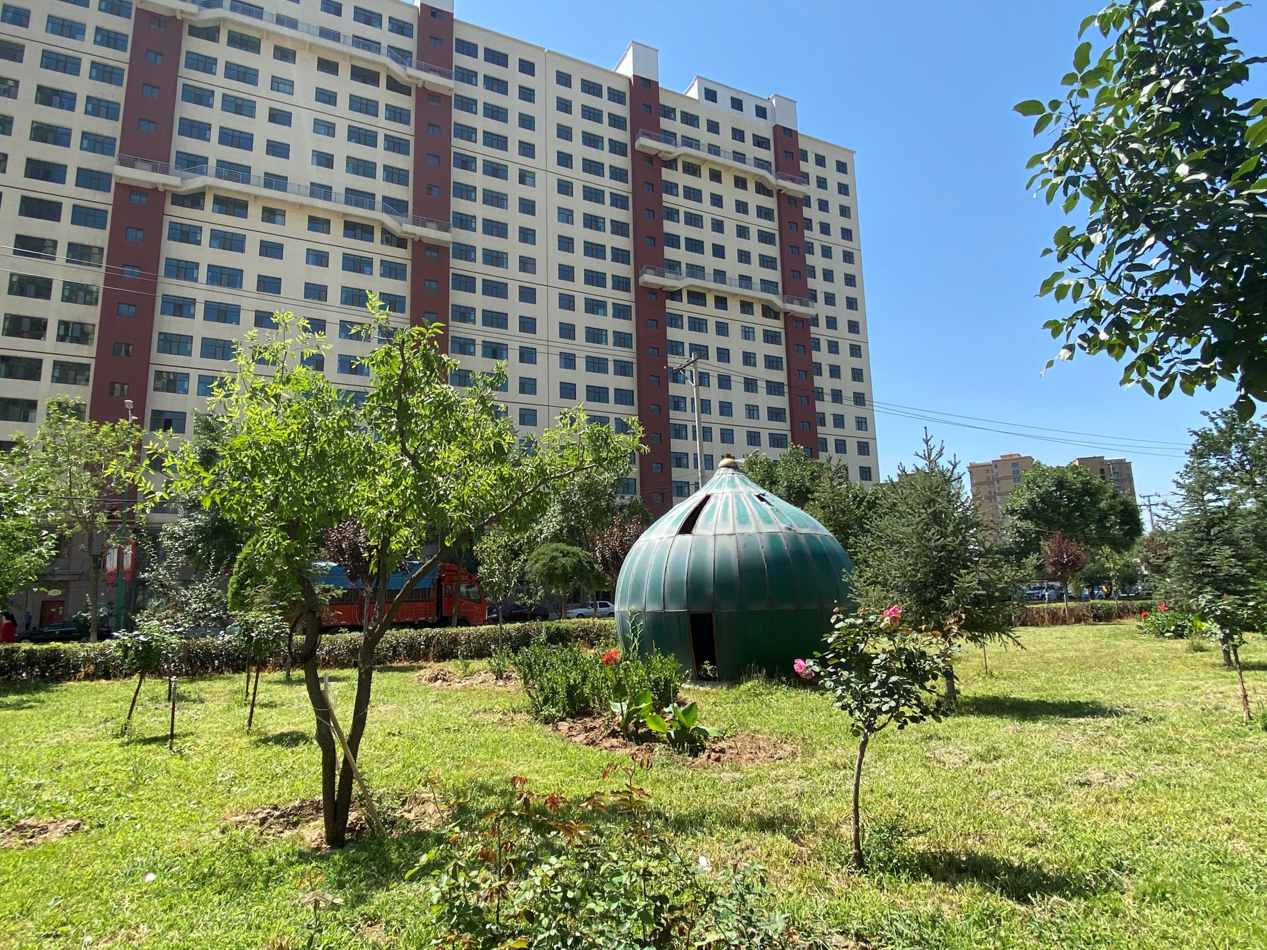 Photograph of a dome on the ground outside of a building