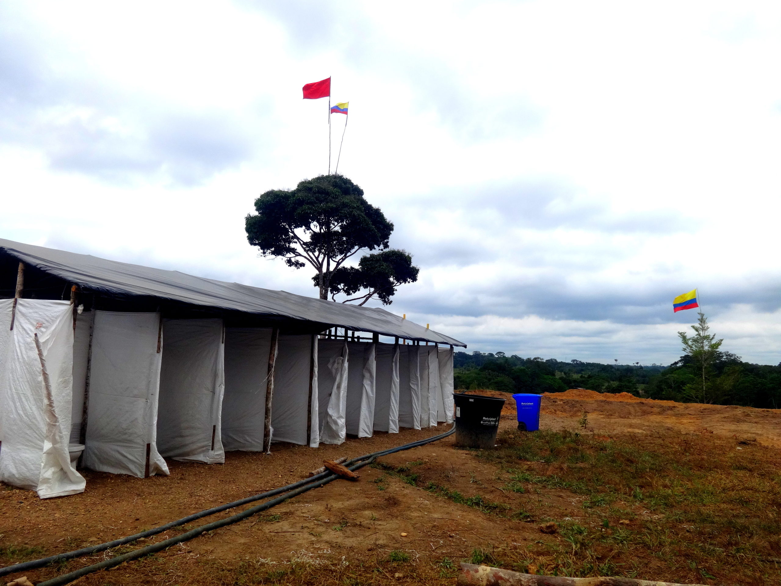 Photograph of temporary showers built in a disarmament camp in Colombia.