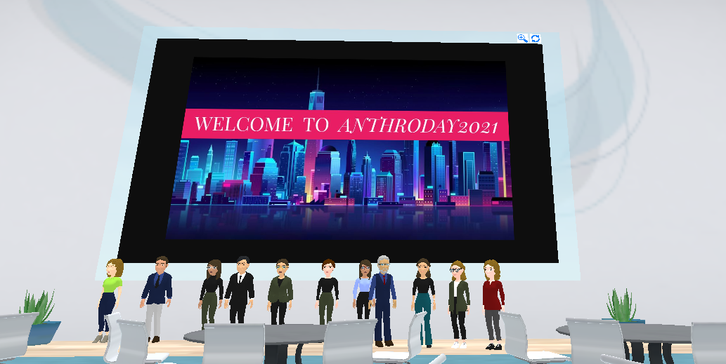 Screenshot of a virtual space including chairs, tables, avatars, and a welcome banner